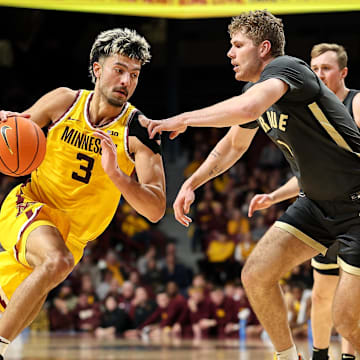 Jan 2, 2025; Minneapolis, Minnesota, USA; Minnesota Golden Gophers forward Dawson Garcia (3) drives towards the basket as Purdue Boilermakers forward Caleb Furst (1) defends during the first half at Williams Arena. Mandatory Credit: Matt Krohn-Imagn Images