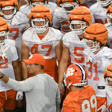 Swinney talks with Clemson players during a spring practice in February.