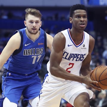 Jan 22, 2019; Dallas, TX, USA;vLA Clippers guard Shai Gilgeous-Alexander (2) looks to pass as Dallas Mavericks forward Luka Doncic (77) defends during the second half at American Airlines Center. Mandatory Credit: Kevin Jairaj-Imagn Images