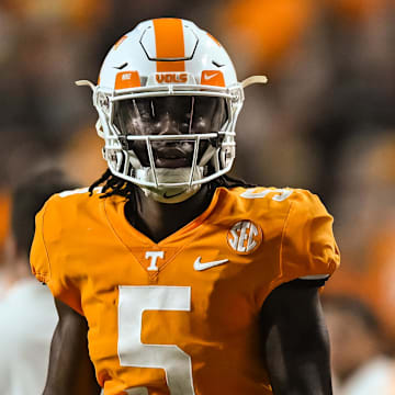 Sep 17, 2022; Knoxville, Tennessee, USA; Tennessee Volunteers quarterback Hendon Hooker (5) and secondary coach Willie Martinez look on during the first half against the Akron Zips at Neyland Stadium. Mandatory Credit: Bryan Lynn-Imagn Images