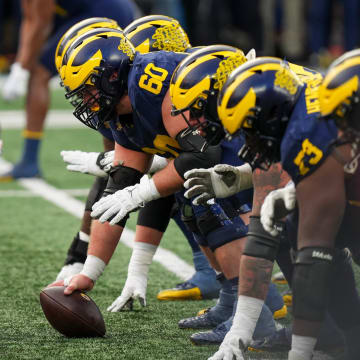 Nov 25, 2023; Ann Arbor, Michigan, USA; Michigan Wolverines offensive lineman Drake Nugent (60) prepares to snap the ball during the NCAA football game against the Michigan Wolverines at Michigan Stadium. Ohio State lost 30-24.