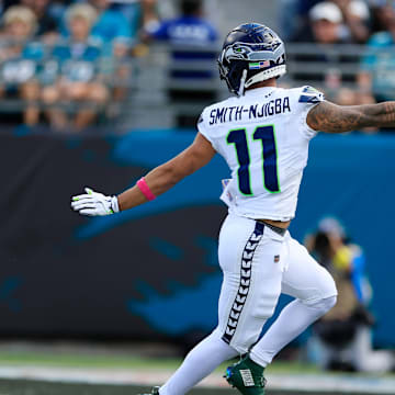 Caption:Seattle Seahawks wide receiver Jaxon Smith-Njigba (11) looks back at Jacksonville Jaguars cornerback Greg Newsome II (6) while scoring a touchdown during the second quarter of an NFL football matchup, Sunday, Oct. 12, 2025, at EverBank Stadium in Jacksonville, Fla. The Seahawks defeated the Jaguars 20-12.