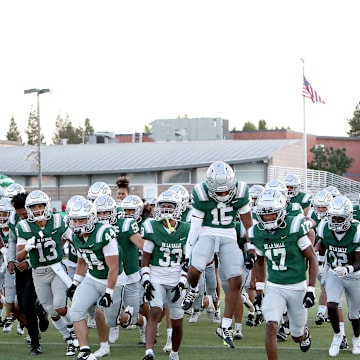 De La Salle players rush the field before the kick off against visiting Grant Union.