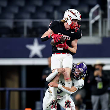 Tight end Garrett Hess of Muenster makes a leaping catch over a Shiner defender during the Texas 2A Division 2 title game at AT&T Stadium.