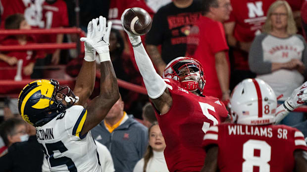 Nebraska Cornhuskers cornerback Cam Taylor-Britt (5) breaks up a pass to Michigan Wolverines wide receiver Daylen Baldwin