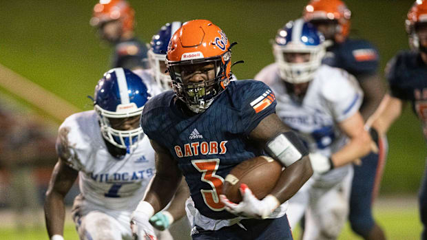 Escambia's Waymond Jordan, Jr. (No. 3) slips past the Washington defense during Friday night's game against the Gators.Whs 