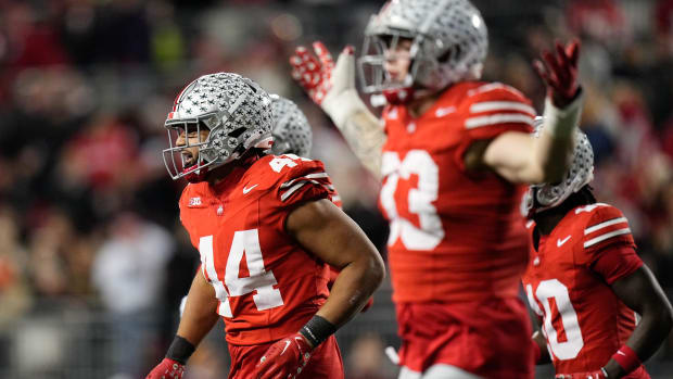 Ohio State Buckeyes defensive players celebrate a turnover during a college football game in the Big Ten.