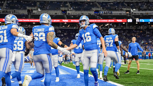 Detroit Lions quarterback Jared Goff (16) shakes hands with teammates during warm up before a preseason game