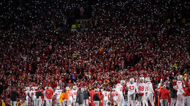 Wisconsin Badgers fans hold their cell phones with flashlights on 