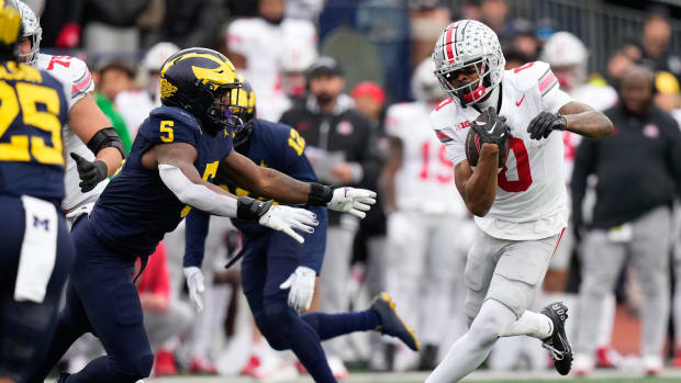 Nov 25, 2023; Ann Arbor, Michigan, USA; Ohio State Buckeyes wide receiver Xavier Johnson (0) runs past Michigan Wolverines de