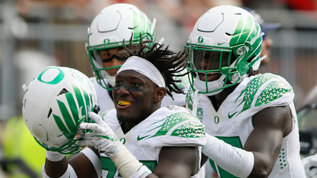 Oregon Ducks safety Verone McKinley III (23) celebrates making an interception with linebacker Adrian Jackson (29) during the