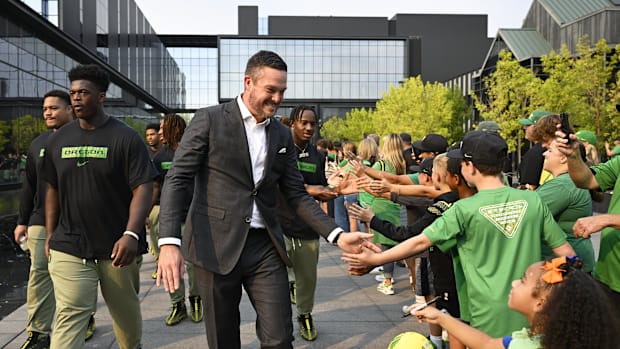 Sep 7, 2024; Eugene, Oregon, USA; Oregon Ducks head coach Dan Lanning high-fives fans as he leads his team before a game agai