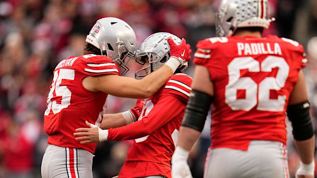 Ohio State Buckeyes place kicker Jayden Fielding (38) celebrates a field goal with tight end Bennett Christian (85) during th