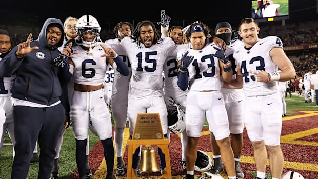 Nov 23, 2024; Minneapolis, Minnesota, USA; Penn State Nittany Lions players pose for a photo with the Governor's Victory Bell