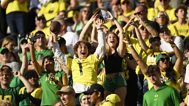 regon Ducks football fans react to seeing themselves on the big screen during the second half in a game against the Illinois 