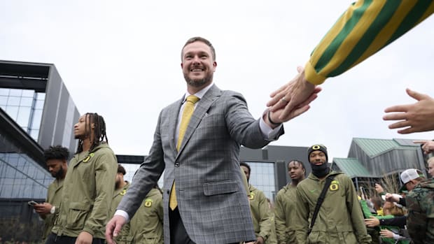 Oregon Ducks head coach Dan Lanning high-fives fans before a game against the Maryland Terrapins at Autzen Stadium. Mandatory