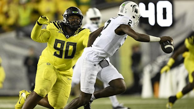 regon Ducks defensive lineman Jamaree Caldwell (90) chases after Michigan State Spartans quarterback Aidan Chiles (2) during 