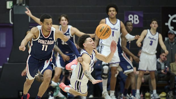 Gonzaga guard Nolan Hickman (11) steals the basketball during the second half against Portland guard Vincent Delano (11). 