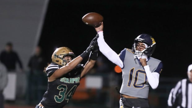 Warren quarterback Madden Iamaleava is under pressure from St. Bonaventure's Jacob Moraga on Nov. 25, 2023.