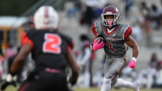 Raines Vikings Jayson Farfan (32) looks for running room during first quarter action.