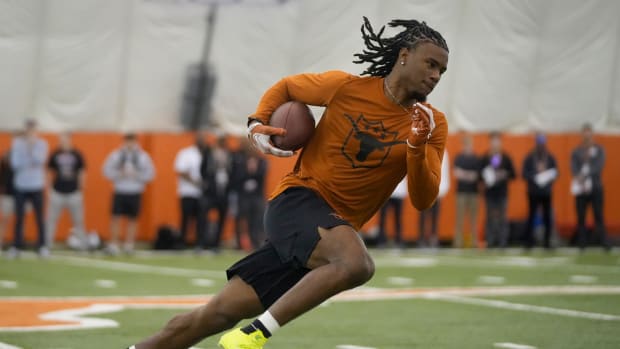 Colts receiver Adonai Mitchell trains while at his college before the 2024 NFL Draft. He's wearing an orange/black outfit. 