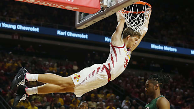 Iowa State guard Nojus Indrusaitis (15) hangs on the rim after a dunk during the Cyclones' season-opening win 