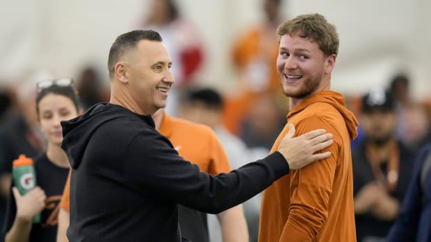 Head coach Steve Sarkisian greets quarterback Quinn Ewers who threw passes to receivers at Texas Longhorns Football Pro Day a