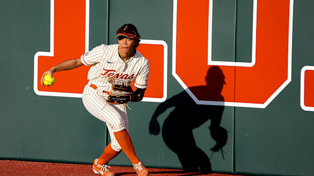Texas lLonghorns outfielder Kayden Henry (21) picks up the ball to throw to first during the game against South Florida on th