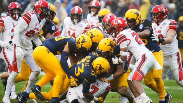 Demari Simpkins (17) is tackled by a host of West Virginia Mountaineers defenders. Credit: Ray Carlin-USA TODAY Sports