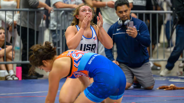 New Jersey's Ella Poalillo (background) reacts after victory in the 160-pound final over Michigan's Kaili Manuel.