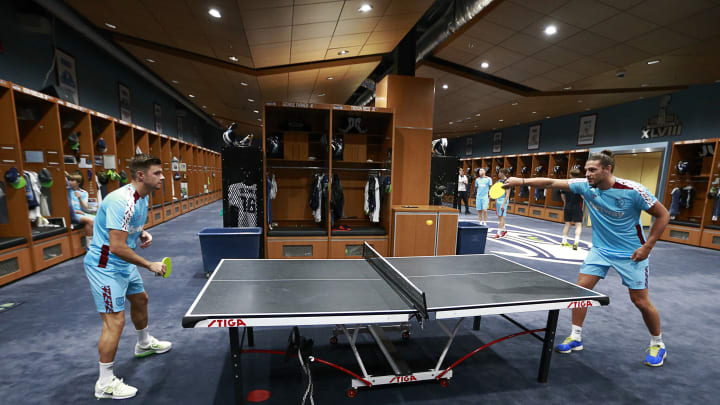 Two West Ham United players play ping-pong at the Seattle Seahawks practice facility. 