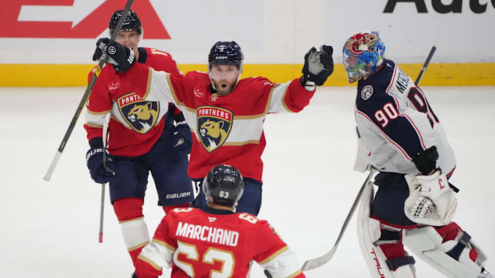 Dec 6, 2025; Sunrise, Florida, USA;  Florida Panthers center Sam Bennett (9) celebrates the winning goal in overtime against the Columbus Blue Jackets with left wing Brad Marchand (63) and center Evan Rodrigues (17) as Columbus Blue Jackets goaltender Elvis Merzlikins (90) leave the ice at Amerant Bank Arena. Mandatory Credit: Jim Rassol-Imagn Images