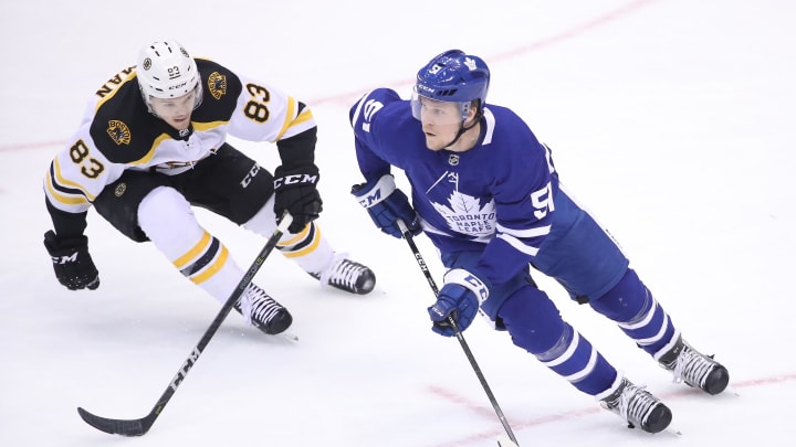 Apr 15, 2019; Toronto, Ontario, CAN; Toronto Maple Leafs defenseman Jake Gardiner (51) skates with the puck in the third period as Boston Bruins center Karson Kuhlman (83) defends in game three of the first round of the 2019 Stanley Cup Playoffs at Scotiabank Arena. Mandatory Credit: Tom Szczerbowski-USA TODAY Sports