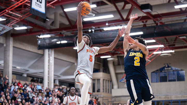 North High's Amir Jenkins soars toward the hoop during Wednesday's win over Xaverian.