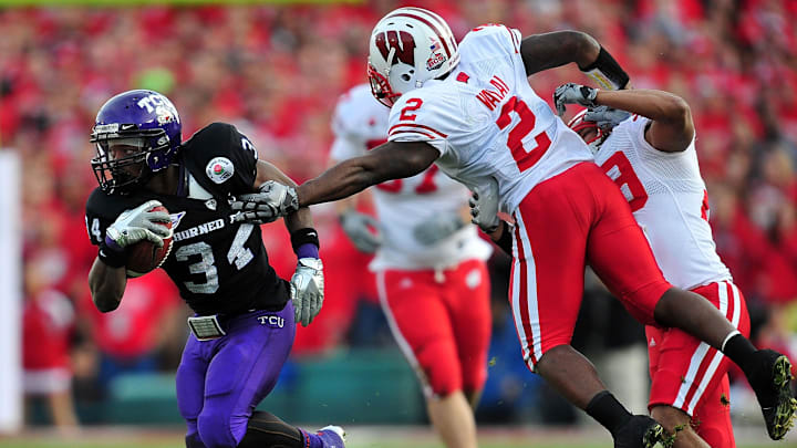 January 1, 2011; Pasadena, CA, USA; TCU Horned Frogs running back Ed Wesley (34) runs the ball against the defense of Wisconsin Badgers cornerback Jay Valai (2) during the second half during the 2011 Rose Bowl. Mandatory Credit: Mandatory Credit: Gary A. Vasquez-Imagn Images