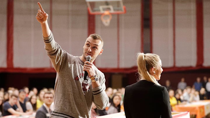 Sheboygan's Sam Dekker, left, points out a projection on the screen by his wife Olivia Harlan Dekker while emceeing the first Sheboygan South Senior Signing Day, Thursday, May 30, 2019, in Sheboygan, Wis. Senior Signing Day is designed to recognize our seniors and their next steps in college and career. 

She 053019 Sheboygan South Senior Sig01ning Day Gck