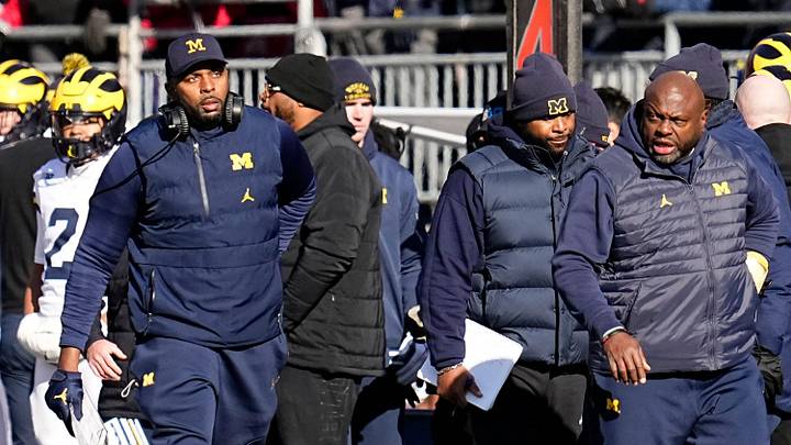 Michigan Wolverines head coach Sherrone Moore and run game coordinator Tony Alford walk along the sideline during the first half of the NCAA football game against the Ohio State Buckeyes at Ohio Stadium in Columbus on Saturday, Nov. 30, 2024.