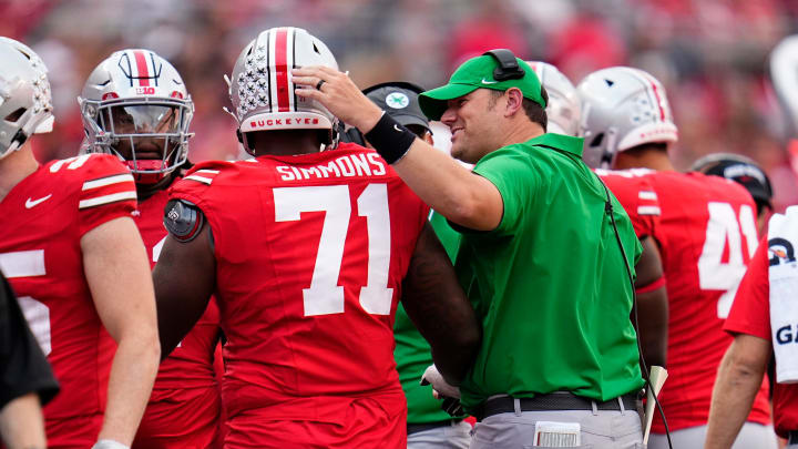 Sep 16, 2023; Columbus, Ohio, USA; Ohio State Buckeyes offensive lineman Josh Simmons (71) gets a pat on the back from coach Justin Frye during the NCAA football game against the Western Kentucky Hilltoppers at Ohio Stadium. Ohio State won 63-10.