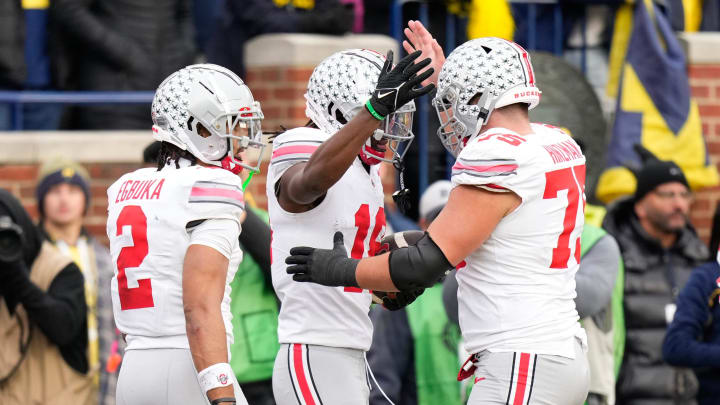 Nov 25, 2023; Ann Arbor, Michigan, USA; Ohio State Buckeyes wide receiver Marvin Harrison Jr. (18) celebrates a touchdown with wide receiver Emeka Egbuka (2) and offensive lineman Carson Hinzman (75) during the second half of the NCAA football game against the Michigan Wolverines at Michigan Stadium. Ohio State lost 30-24.