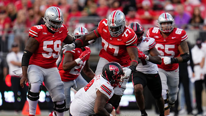 Sep 16, 2023; Columbus, Ohio, USA; Ohio State Buckeyes offensive lineman Tegra Tshabola (77) goes to tackle Western Kentucky Hilltoppers defensive tackle Hosea Wheeler (98) during the NCAA football game at Ohio Stadium. Ohio State won 63-10.