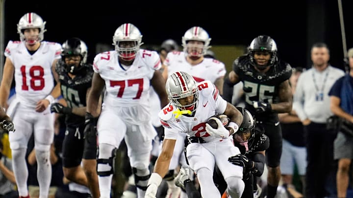 Oct 12, 2024; Eugene, Oregon, USA; Ohio State Buckeyes wide receiver Emeka Egbuka (2) gets tackled by Oregon Ducks defensive back Brandon Johnson (3) after a catch in the second half during the NCAA football game at Autzen Stadium