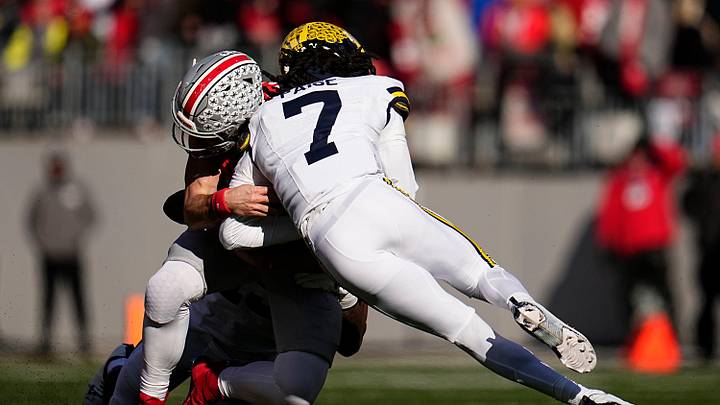 Ohio State Buckeyes quarterback Will Howard (18) is hit by Michigan Wolverines defensive back Makari Paige (7) during the first half of the NCAA football game at Ohio Stadium in Columbus on Saturday, Nov. 30, 2024. Howard left the game briefly after the play.