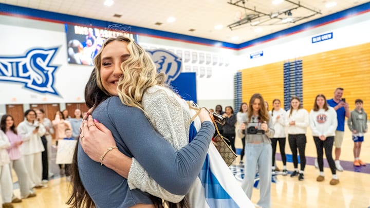 Maya Makalusky gets a hug from her sister, Riley, after being named IndyStar Miss Basketball on Wednesday, March 19, 2025, at Hamilton Southeastern High School in Fishers.