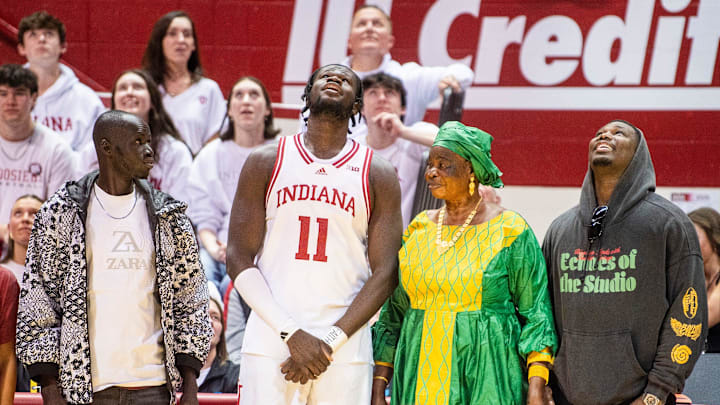 Indiana's Oumar Ballo (11) watches a video presentation with his family during Senior Day festivities after the Indiana versus Ohio State men's basketball game at Simon Skjodt Assembly Hall on Saturday, March 8, 2025.