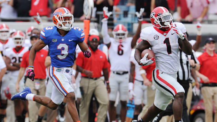 Georgia's #1, Sony Michel runs 75 yards for a touchdown while being pursued by Florida's #3, Marco Wilson for Georgia's third touchdown in the first half to the first quarter of play. Fans started the party early outside EverBank Field before the start of Saturday's Georgia vs Florida college football game Saturday, October 28, 2017 in Jacksonville, Florida. The Bulldogs got ahead early with a halftime score of 21 to 0 over the Gators. (Bob Self/Florida Times-Union)