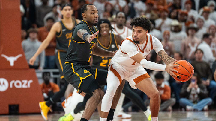Texas Longhorns guard Jordan Pope (0) protects the ball from Missouri Tigers center Trent Burns (7) as the Longhorns take on Mizzou at the Moody Center on Jan. 21, 2025.