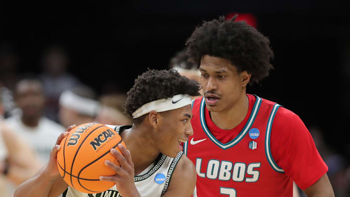 Michigan State Spartans guard Jeremy Fears Jr. (1) keeps the ball away from New Mexico Lobos guard Tru Washington (3) during the second half of an NCAA Tournament Second Round game at Rocket Arena on Sunday, March 23, 2025, in Cleveland, Ohio.