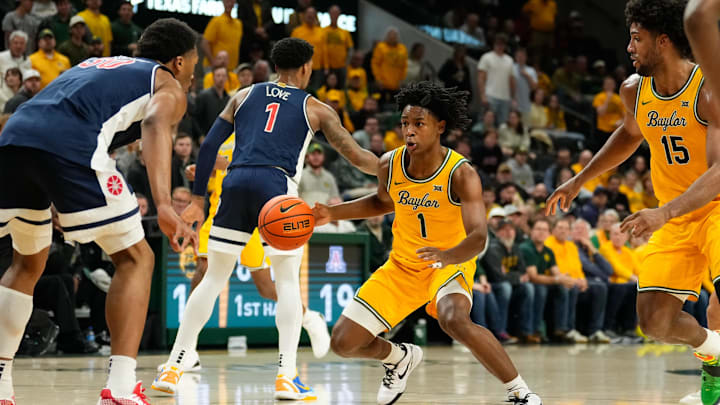 Feb 17, 2025; Waco, Texas, USA;  Baylor Bears guard Robert Wright III (1) controls the ball as Arizona Wildcats forward Tobe Awaka (30) defends during the first half at Paul and Alejandra Foster Pavilion. Mandatory Credit: Chris Jones-Imagn Images
