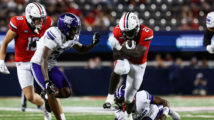 Sep 6, 2025; Tucson, Arizona, USA; Arizona Wildcatsts running back Ismail Mahdi (21) attempts to run past the Weber State Wildcats during the second quarter of the game at Arizona Stadium. Mandatory Credit: Aryanna Frank-Imagn Images