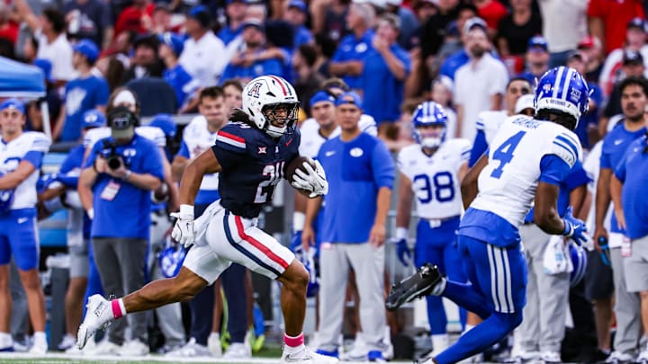 Oct 11, 2025; Tucson, Arizona, USA; Arizona Wildcats running back Quincy Craig (24) runs a first down during the first quarter of the game against the Brigham Young Cougars at Arizona Stadium. Mandatory Credit: Aryanna Frank-Imagn Images